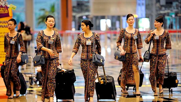 Singapore Girls ... Singapore Airlines flight attendants will now be able to serve for three more years.
