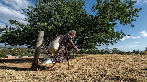 Effie on her way to feed the goats.