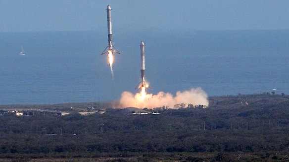 Two booster rockets from the Falcon 9 SpaceX heavy, return for a landing at the Kennedy Space Center in Cape Canaveral, Florida.