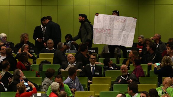 Protesters in the audience at the Labor national conference.