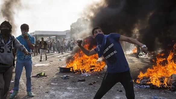 Horgos, Serbia. A protesting refugee throws projectiles at Hungarian police at the Horgos border crossing in Serbia. 