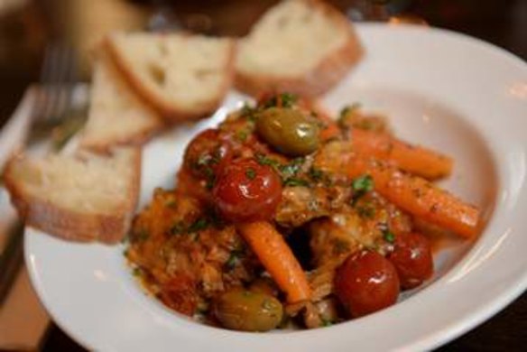 Braised rabbit with cherry tomatoes, carrots and olives.