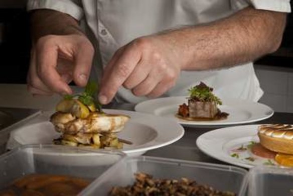 Food&Wine. Restaurant review. Sculpture Garden restaurant at the National Gallery of Australia. Head Chef Eric Menarol preparing crispy roast chicken served with parmesan and sage potatoes, slow baked apple and a cider sauce. February 17th. 2013 Photo Katherine Griffiths, The Canberra Times.