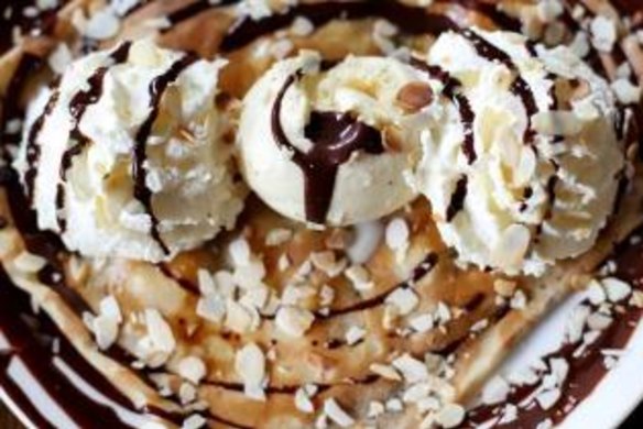 Colossal: Chocolate, banana, whipped cream, grilled almonds and vanilla ice cream crepe at Four Frogs Creperie.