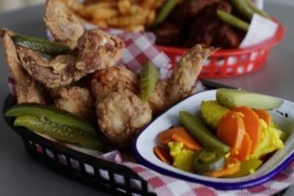 Chicken wings and pickles at Belles Hot Chicken pop-up.