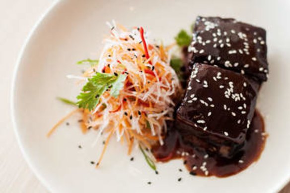 Sticky twice-cooked pork belly with carrot and daikon salad.