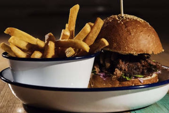 SYDNEY, AUSTRALIA - APRIL 09:  Pulled pork burger with fries at The Public in Cammeray on April 9, 2015 in Sydney, Australia.  (Photo by Christopher Pearce/Fairfax Media)