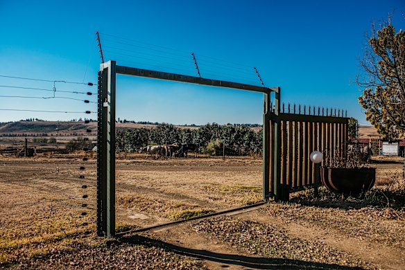 A large security fence surrounds the Muller's property. 