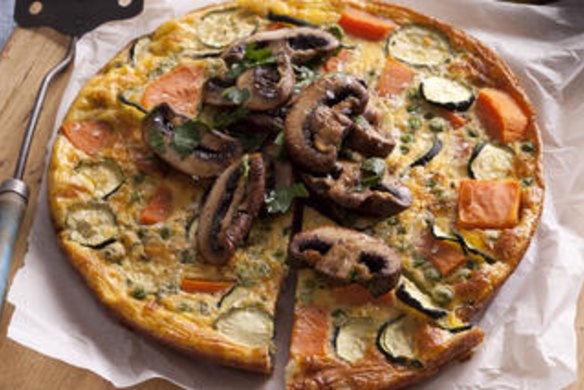 Sweet potato frittata with pan-roasted mushrooms. Jill Dupleix BREAKFAST recipes for Epicure and Good Living. Photographed by Marina Oliphant. Food preparation and styling by Caroline Velik. Wooden board and napery from Manon bis. MUST CREDIT. Photographed March 22, 2012. The Age Newspaper and The Sydney Morning Herald.