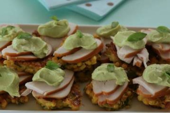 Mini corn cakes with smoked chicken and avocado mayonnaise.