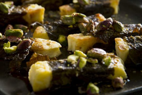 Haloumi wrapped in vine leaves with pistachios and zaatar.
