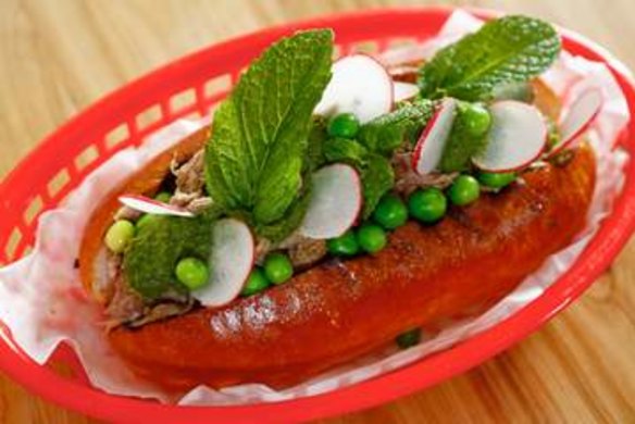 A lamb roll topped with peas, radish and mint.