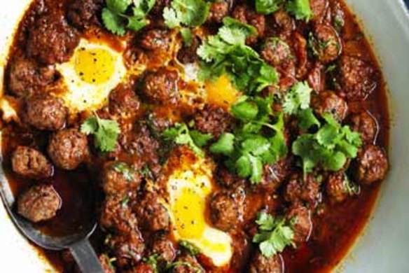 Meatballs and eggs in spicy tomato sauce.