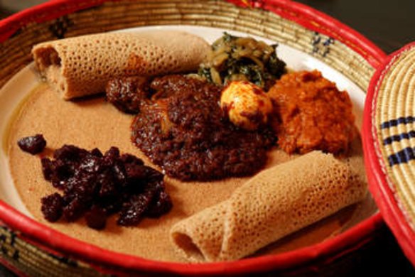 Red split lentils, chicken, diced beetroot and silverbeet served on injera bread at Saba's Ethiopian Restaurant.