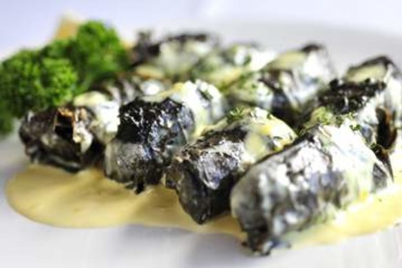 Dolmathes - vine leaves stuffed with spiced beef and rice with a light creamy lemon sauce.