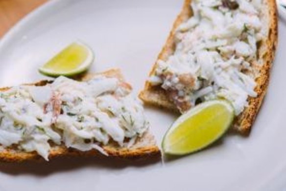 Mud crab with fresh herbs on toast.