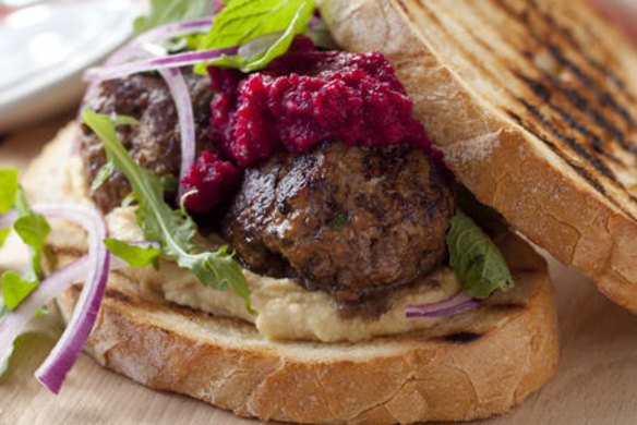 Meatball sandwich with hummus and beetroot.