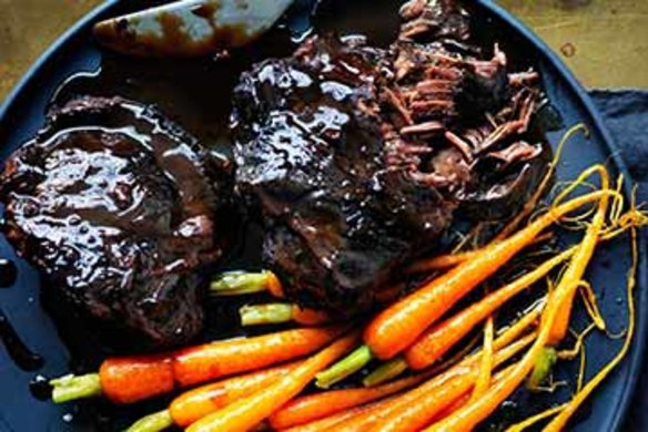 Braised beef cheeks with baby carrots.