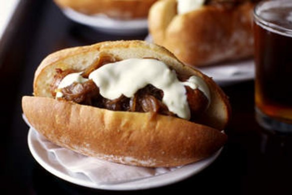 PIC SHOWS SAUSAGE AND BUN.  PIC BY JENNIFER SOO, SMH.  Shows sausages in  bread rolls with onion confit and aioli.