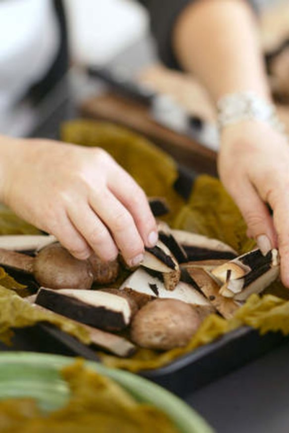 Brigitte Hafner prepares mushrooms in vine leaves.