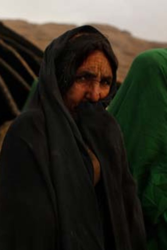 What future? Afghan Kuchi woman Sarwara (second from the left) surrounded by female relatives in front of their makeshift mud-walled tent home at the base of the mountains surrounding Shahid Assas town.