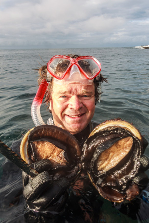 Tour operator Rob Pennicott harvests abalone.