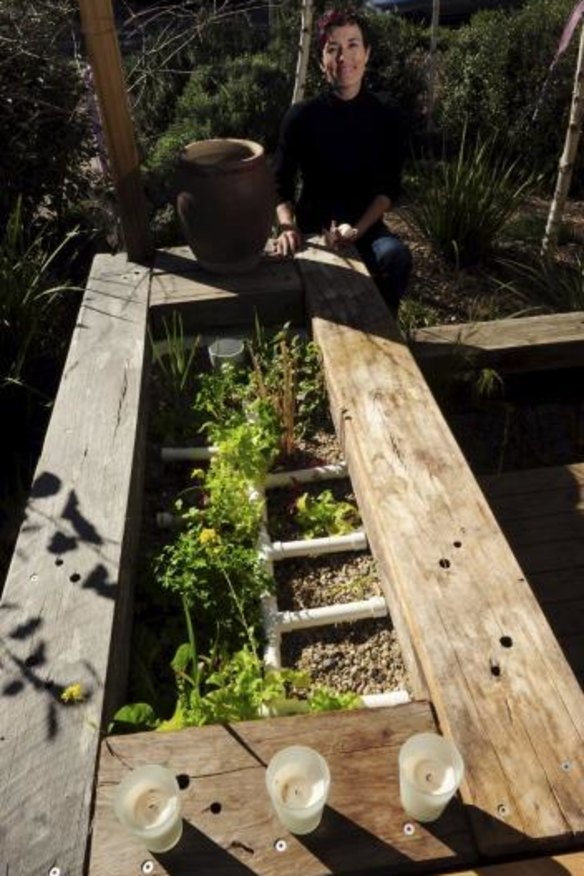 Edwina Robinson with her aquaponic system on her front deck.