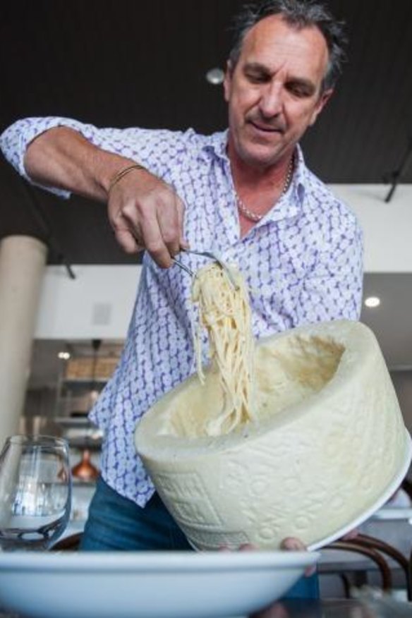 The signature dish, spaghetti cacio e pepe, which is served at the table by a waiter who scoops pasta out of a giant, hollowed-out wheel of cheese.