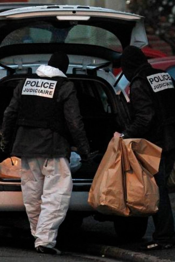 French police carry bags containing evidence outside the five-storey apartment building special forces police killed gunman Mohamed Merah in Toulouse.