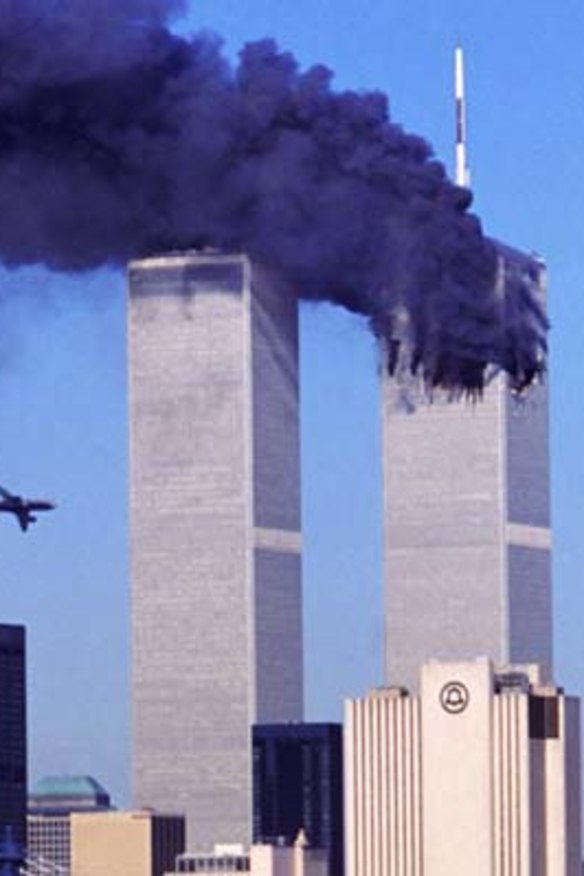 As the north tower of the World Trade Center burns after being struck by hijacked American Airlines Flight 11, hijacked United Airlines Flight 175 nears the south tower.
