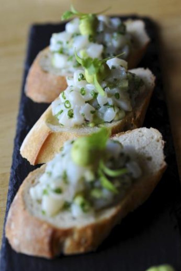 Scallop tartare on toast with avocado and wasabi.