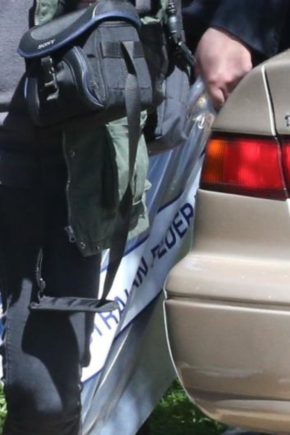 Police take away a sword from Booth Street in Marsfield.  