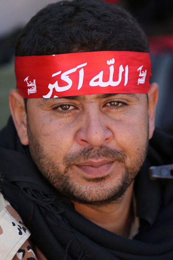 A volunteer Shiite fighter prepares to join the battle against IS for control of the Iraqi city of Tikrit.