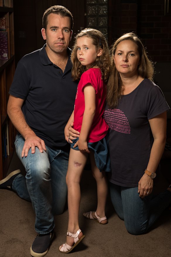 Madeleine Danaher, with parents Tom and Lorelie, shows the scar from her ulcer.