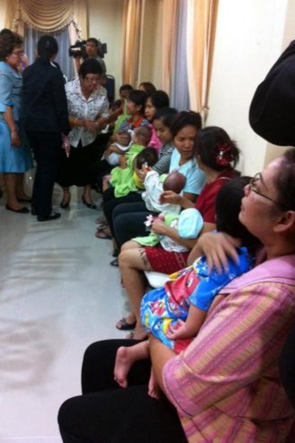 Nannies hold some of the nine babies alleged to be the surrogate children of one Japanese man, Shigeta Mitsutoki.