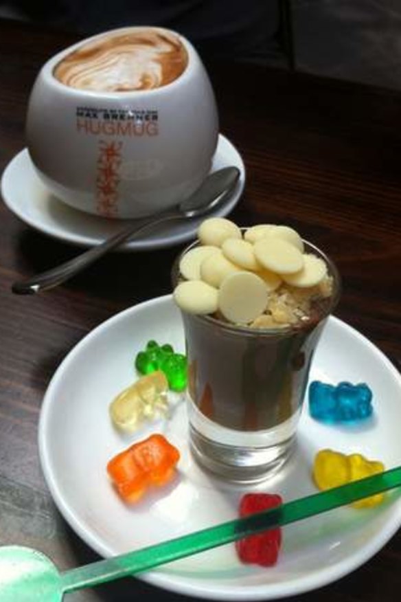 Max Brenner's hot chocolate served in a hug mug and a chocolate shot.