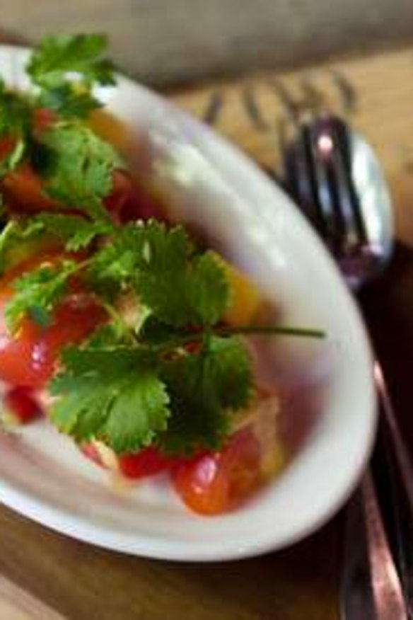 Salad of tomato, pineapple and salted grapes.