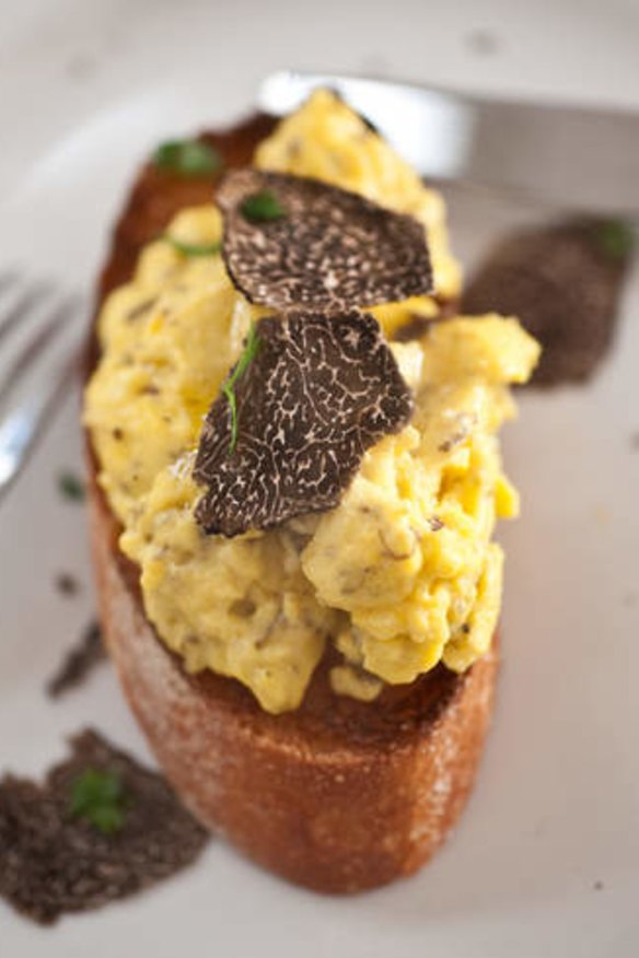 Scrambled truffled eggs on toast with shaved truffle.