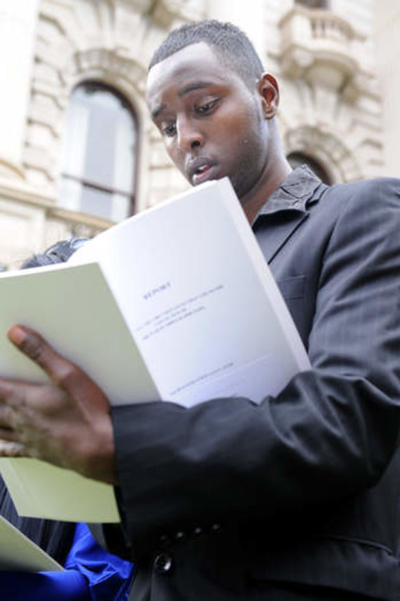 Vindicated: Farah Jama reads from the 2010 report by Frank Vincent, QC, into his case.