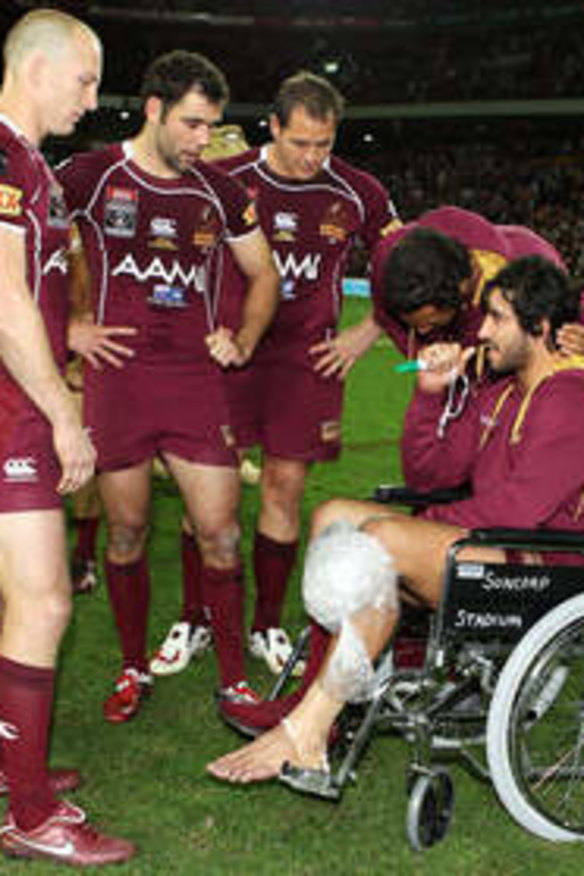 Origin flashback 2011: Darren Lockyer, Cameron Smith and Matt Scott speak to Johnathan Thurston in a wheelchair after injuring his knee during game three of the State of Origin series.