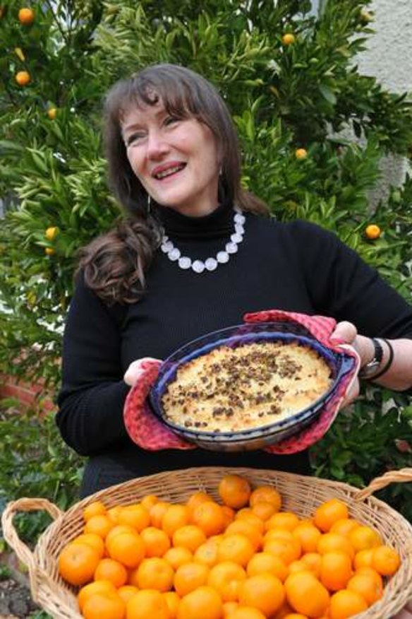 Janet Hughes with her cumquat crumble and a basket of harvested fruit from one of her cumquat trees.