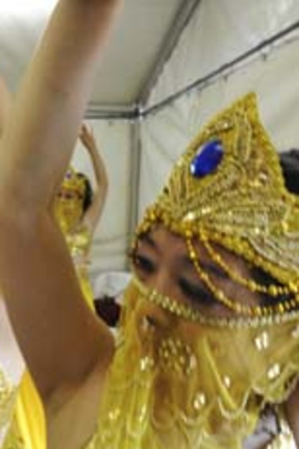 Celebrating the new year ... performers rehearse The Golden Snake Dance backstage.