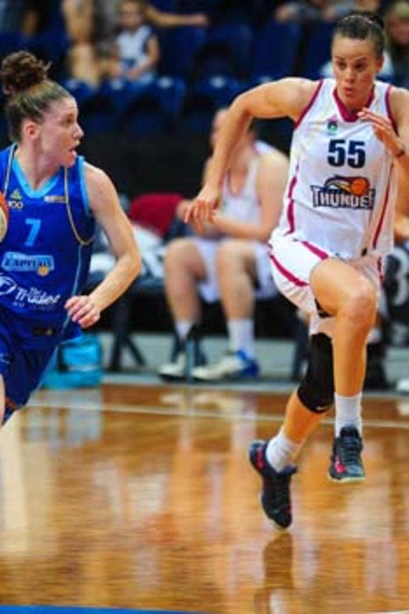 Natalie Hurst of the Canberra Capitals and Kristen Veal of Logan Thunder during a WNBL game in December.
