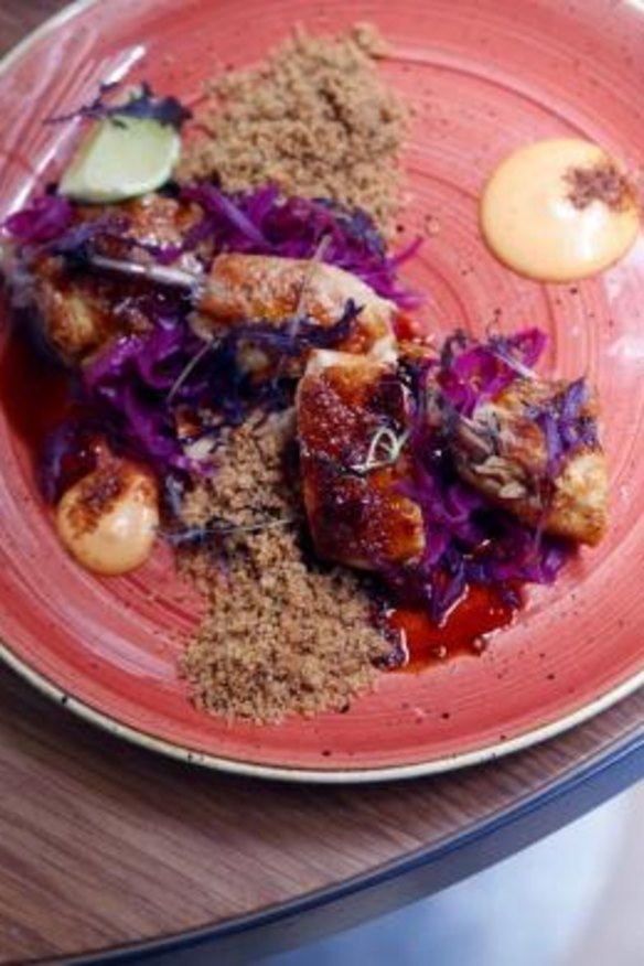 Blackened chicken with cabbage and chicken skin crumble.