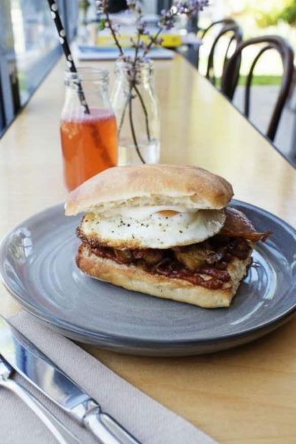 Bacon, egg & hash roll with house bbq sauce at Halcyon Coffee. 