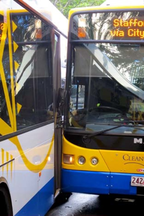 Two buses sit on Adelaide Street after colliding.