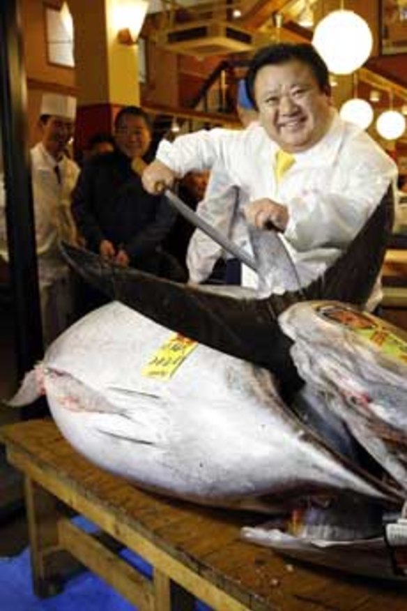 Kiyomura Co's President Kiyoshi Kimura, who runs a chain of sushi restaurants, poses with a bluefin tuna in front of his sushi restaurant outside Tsukiji fish market in Tokyo.