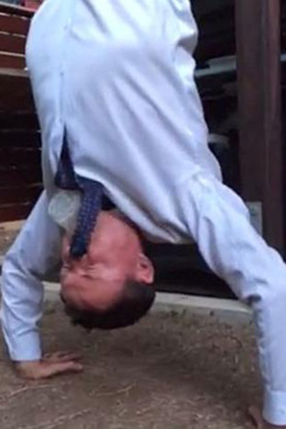 The Facebook image of Andrew Laming skolling a beer while doing a handstand.