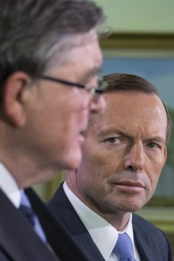 PM Tony Abbott watches as ASIO chief David Irvine explains the increase in terror threat level. 