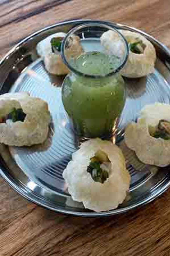 The pani puri, served with a spiced broth, is a one-bite fiesta.